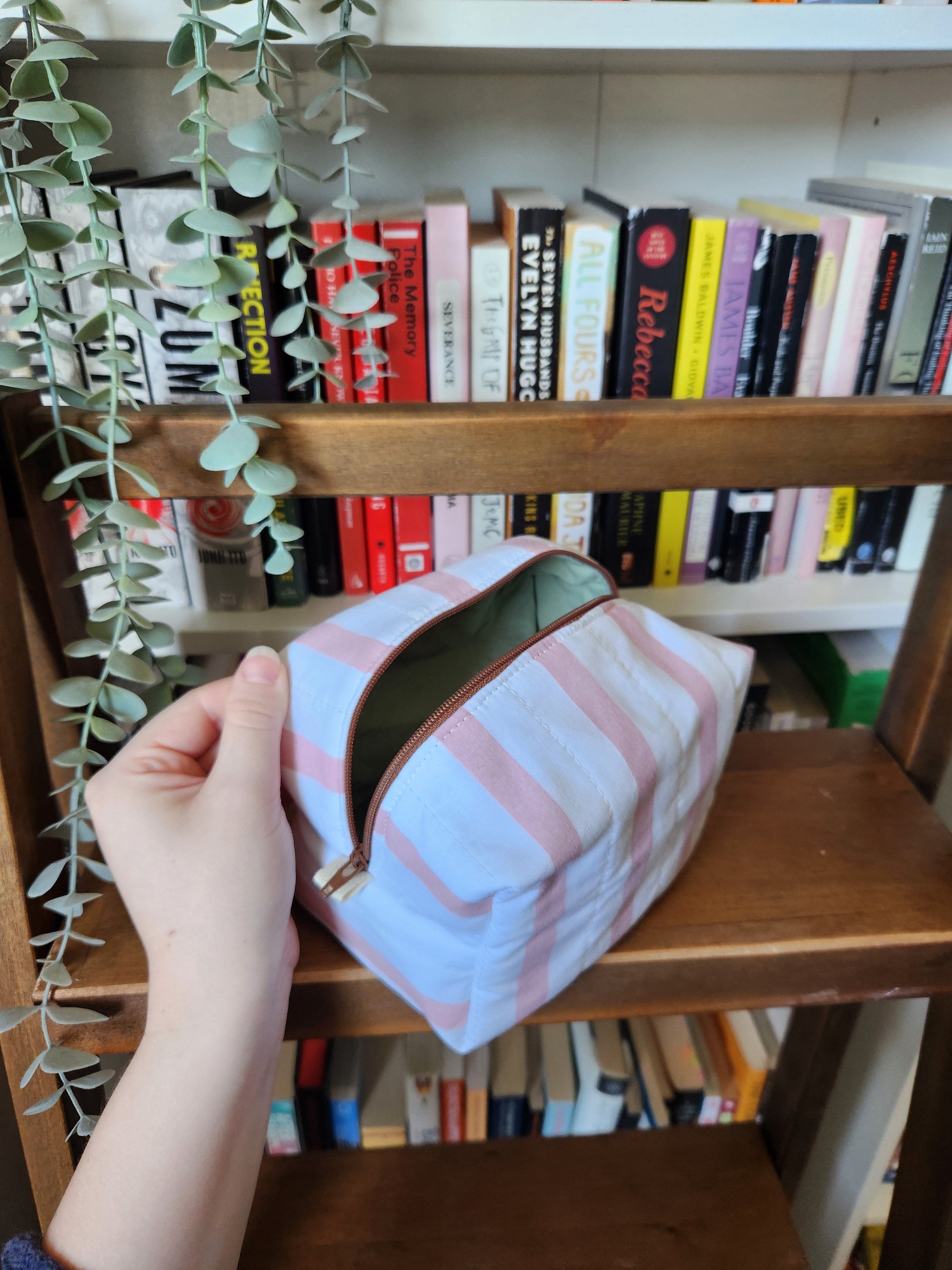 pink and white stripey makeup bag (brown zipper)